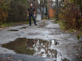 Ken Kozyra in his back alley for a story on the poor conditions of back alleys and the city says is will cost $18 million a year to fix in Edmonton, Friday, October 28, 2016. Ed Kaiser/Postmedia