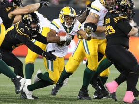 Edmonton Eskimos running back John White runs for some yards during CFL action against the Hamilton Tiger-Cats in Hamilton on Oct. 28, 2016. (THE CANADIAN PRESS/Peter Power)