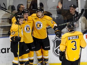 Kingston Frontenacs' Liam Murray celebrates with teammates Sergey Popov, 47, left, Cody Caron, 27, and Warren Foegele after scoring the second goal of the game in the final seconds of the first period during Ontario Hockey League action against the Flint Firebirds at the Rogers K-Rock Centre in Kingston on Friday.  (Julia McKay/The Whig-Standard)