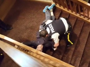 A video shows an elderly man being dragged down stairs by several police officers at the Best Western in Coquitlam, B.C. On Thursday. Coquitlam RCMP is conducting a review of the officers' actions. (Screen capture)