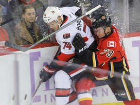 Calgary Flames Micheal Ferland loses his stick as he collides with Ottawa Senators Mark Borowiecki in NHL action at the Scotiabank Saddledome in Calgary on Oct. 28, 2016. (Mike Drew/Postmedia)
