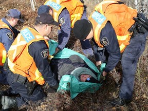 Members of the Greater Sudbury Police search and rescue team take part in a training scenario in Azilda, Ont. on Friday October 28, 2016. the Greater Sudbury Police partnered with the Alzheimer Society Sudbury-Manitoulin North Bay & Districts to help promote awareness  of alzheimer’s and related dementias by conducting a  search and rescue involving a scenario where a vulnerable person had to be rescued. John Lappa/Sudbury Star/Postmedia Network