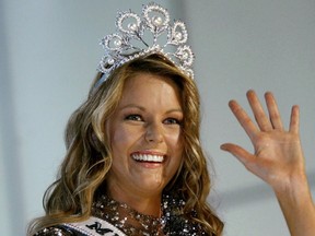 FILE - In this June 1, 2004 file photo, Miss Australia Jennifer Hawkins celebrates as she was crowned Miss Universe, at a convention center in Quito, Ecuador. Hawkins said Saturday, Oct. 29, 2016 that Donald Trump had always treated her with respect after a video emerged of an embarrassing exchange between the pair in Sydney in 2011. (AP Photo/Silvia Izquierdo, File)