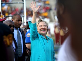 Democratic presidential candidate Hillary Clinton waves to supporters as she makes her way through the crowd at the Bethune-Cookman University homecoming football game, in Daytona Beach, Fla., Saturday, Oct. 29, 2016. (Joe Burbank/Orlando Sentinel via AP)