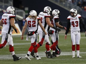 Ottawa Redblacks players congratulate Ray Early (43) on his field goal during the second half of CFL action against the Winnipeg Blue Bombers in Winnipeg Saturday, October 29, 2016. (THE CANADIAN PRESS/John Woods)