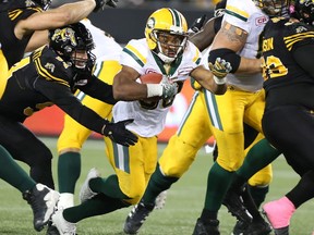 Edmonton Eskimos running back John White (30) runs for some yards during the second-half of CFL football action against the Hamilton Tiger-Cats in Hamilton on Friday, October 28, 2016.