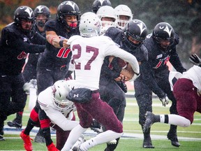 Carleton Ravens’ Jayde Rowe tries to run over Cody Cranston of the Ottawa Gee-Gees on Oct. 29. (Ashley Fraser, Postmedia Network)