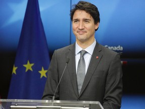 Prime Minister Justin Trudeau prepares to address a media conference at the end of an EU-Canada summit at the European Council building in Brussels, Sunday, Oct. 30, 2016.  (AP Photo/Olivier Matthys)