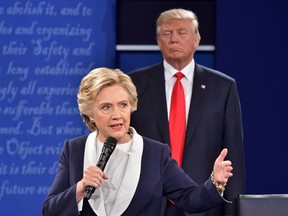 Republican presidential candidate Donald Trump listens to Democratic presidential candidate Hillary Clinton during the second presidential debate at Washington University in St. Louis, Missouri on Oct. 9, 2016. (PAUL J. RICHARDS/AFP/Getty Images)