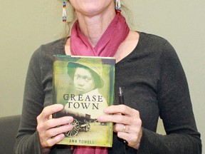 Children's author Ann Towell spoke about her journey as a writer recently during Sombra Museum's lecture series. She's pictured holding a copy of her novel Grease Town. (Carl Hnatyshyn, Postmedia Network)