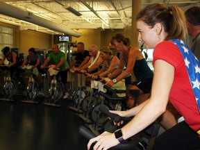 Caroline Livingston, one of the organizers of the Spinathon for the United Way, takes part in the event at the Invista Centre on Saturday. (Steph Crosier/The Whig-Standard)
