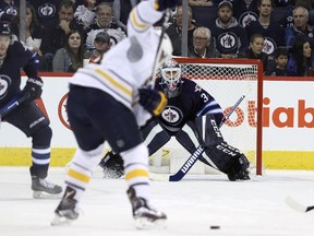 Buffalo Sabres forward Kyle Okposo (#21) winds up to shoot on Winnipeg Jets goaltender Michael Hutchinson (#34) during second period NHL action in Winnipeg on Sunday, Oct. 30, 2016. (THE CANADIAN PRESS/Jason Halstead)