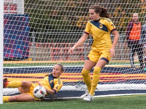 Queen's Gaels' Erin Cliffe dives at her own goal-line to stop a ball that got past goalie Madison Tyrell during an OUA women's soccer playoff game at Richardson Stadium on Sunday. Looking on is the Gaels' Rachel Radu. Queen's won 1-0 in overtime. (Tim Gordanier/The Whig-Standard)