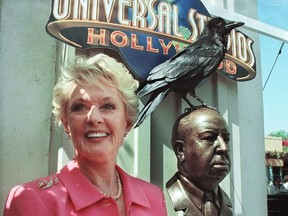 Former actress Tippi Hedren stands next to the unveiled bronze bust of the late director Alfred Hitchcock during a June 27, 1999 ceremony at Universal Studios in Los Angeles, California. (SCOTT NELSON/AFP/Getty Images)
