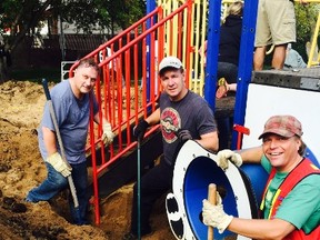 Castle Downs Recreational Society volunteers dismantle a playground to be donated to a rural community in Cambodia.