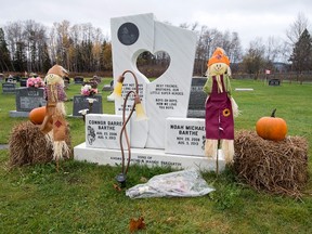 The grave of Noah and Connor Barthe, decorated for Halloween, is seen in Tide Head, N.B., Sunday, Oct. 30, 2016. Jean-Claude Savoie is charged with criminal negligence causing death after the two young brothers were asphyxiated by an African rock python in Campbellton in August 2013. Jury selection begins on Monday, Oct. 31, 2016. (THE CANADIAN PRESS/Andrew Vaughan)