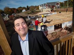 Brian Elliot is the new exec director of Habitat for Humanity in London, Ont. Behind him are two homes being built on Forbes St. Derek Ruttan/The London Free Press/Postmedia Network