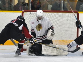 Mitchell Hawks’ goalie Graeme Lauersen is aided by teammate Chad Lemire (17) as a loose puck sits close to the Mitchell net during second period action of their PJHL Pollock Division game Saturday night, Oct. 29, a 3-2 win over Walkerton in overtime. ANDY BADER MITCHELL ADVOCATE