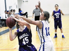 Erica Babb (10) of the MDHS senior Blue Devils plays strong defence against FE Madill of Wingham from early season action. ANDY BADER MITCHELL ADVOCATE