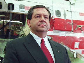 In this file photo, former FBI Assistant Director James Kallstrom stands in front of a reconstructed portion of the wreckage from TWA flight 800. In a radio interview, Kallstrom described the Clintons as a crime family. (JON LEVY/AFP/Getty Images).