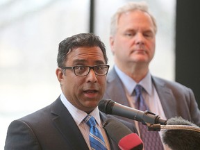 WRHA Chief Medical Officer Dr. Brock Wright (right) and cardiac surgeon Dr. Rakesh Arora speak to the media on Monday. (Brian Donogh/Winnipeg Sun)