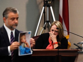 Leanna Taylor cries as defense attorney Maddox Kilgore shows the jury a picture of her son Cooper during a murder trial for her ex-husband Justin Ross Harris who is accused of intentionally killing Cooper in June 2014 by leaving him in the car in suburban Atlanta, Monday, Oct. 31, 2016, in Brunswick, Ga. (AP Photo/John Bazemore, Pool)