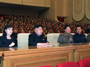 This undated picture, released by North Korea's official Korean Central News Agency (KCNA) on May 13, 2013, shows North Korean leader Kim Jong Un, centre, accompanied by his wife Ri Sol Ju, left, enjoying a performance given by the Song and Dance Ensemble of the Korean People's Internal Security Forces (KPISF) in Pyongyang. (KNS/AFP/Getty Images)