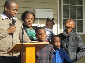 Gabriel Tshangala, with his wife Maguy and their children, from left, Jasheil, Emily, Ben and Eliel, take part in a key ceremony Habitat for Humanity Sarnia-Lambton held on Monday October 31, 2016 at the family's new home on Devine Street in Sarnia, Ont. (Paul Morden/Sarnia Observer/Postmedia Network)