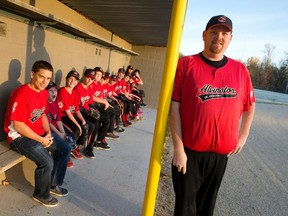 Coaches Andy Triest, left, and Dan Cumming, right, are joined by players from their local youth baseball association team, the Alvinston Indians, in the dugout of their home field southwest of London in Alvinston. Having mulled it over for the past few years, the board of the team has decided to replace it's Chief Wahoo logo, popularized by the Cleveland Indians who are facing calls to do the same during their World Series run. The association is raising $29,000 for new team uniforms, signage, and a scoreboard, all of which feature the logo. (CRAIG GLOVER, The London Free Press)