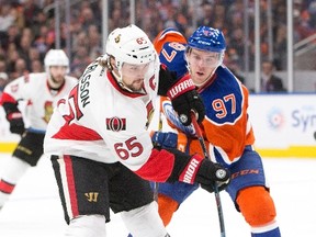 Senators captain Erik Karlsson battles Oilers star Connor McDavid on Oct. 30. (The Canadian Press)