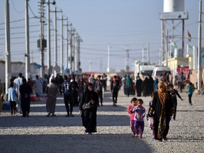 Iraqis walk through Debaga refugee camp where people displaced by fighting in and around Mosul have sought shelter, on October 22, 2016 in Debaga near Mosul, Iraq. (Carl Court/Getty Images)