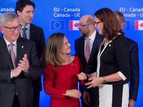 Canadian Minister of International Trade Chrystia Freeland, centre, and European Trade Commissioner Cecilia Malmstrom, right, during the ceremony of the signing of the Comprehensive Economic and Trade Agreement (CETA) at the European Council in Brussels, on October 30, 2016.(THIERRY MONASSE/AFP/Getty Images)