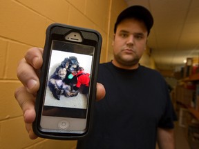 Dylan Gray shows a photograph of a puppy he purchased from Cedar Lanes at the Trails End Market. The dog died from parvovirus. (CRAIG GLOVER, The London Free Press)