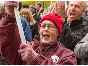 Christine Collins and her fellow PSAC members demonstrate in front of Prime Minister Justin Trudeau's offices in the Langevin Block at Wellington and Elgin Streets to remind him to make good on his word to respect public services and the people who provide them. photo by Wayne Cuddington/ Postmedia WAYNE CUDDINGTON / POSTMEDIA