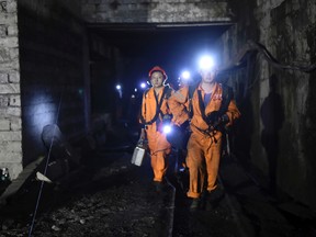 In this Monday, Oct. 31, 2016 photo released by China's Xinhua News Agency, rescuers work at Jinshangou Coal Mine in Chongqing, southwest China. Rescuers worked through the night at the privately owned Jinshangou mine where the explosion occurred before noon Monday, Xinhua News Agency reported. (Tang Yi/Xinhua via AP)