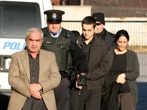Mohammad Shafia (left), his wife Tooba Mohammad Yahya and their son Hamed arrive for court in KIngston on December 12, 2011. They are each charged with four counts of first degree murder in the deaths of four other family members. Their bodies were found in a submerged car in the Kingston Mills Locks on June 30th 2009. IAN MACALPINE/Postmedia Network