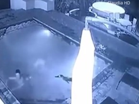 CCTV footage captured the terrifying moment a crocodile crashed a couple’s moonlight swim and lunged at them. (YouTube screen grab)