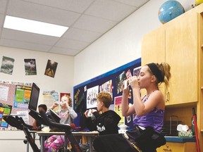 Samantha Divincenzo, a Grade 6 student at St. Theresa Catholic School, conducts a science experiment on aerodynamics while riding one of her classroom’s spin bikes — an initiative teacher Kurt Davis says has seen nothing but positive comments from parents and students.

Photo by Sarah Comber/Sherwood Park News/Postmedia Network