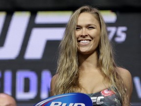 In this July 4, 2014, file photo, Ronda Rousey stands on the scale during a weigh-in for the UFC 175 mixed martial arts event at the Mandalay Bay in Las Vegas. U.S. (AP Photo/John Locher, File)