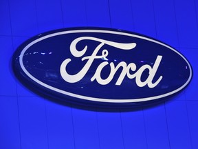 This file photo taken on January 31, 2012 shows the Ford logo is seen at the Washington Auto Show at the Walter E. Washington Convention Center in Washington, DC. The Canada Auto Workers said November 1, 2016 an agreement had been reached for a new collective agreement with Ford, avoiding a strike in the factories of the American manufacturer in Canada. "Ford Canada and Unifor reached an agreement for a contract over four years to more than 6,400 unionized Canadian employees", the statement of Unifor union. The agreement was reached just before midnight Monday, the deadline for a strike in Ford plants in Canada. (KAREN BLEIER/AFP/Getty Images)