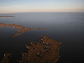 The sun sets over the Gulf of Mexico and Barataria Bay April 13, 2011 near Grand Isle, Louisiana. Scientists have discovered a salt water 'Jacuzzi of Despair' at the bottom of the Gulf of Mexico that kills anythign that swims into it. (Photo by Mario Tama/Getty Images)