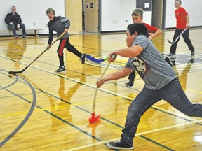Mack Rondilla shoots during a game of ball hockey Oct. 25 in the gym at Vulcan Prairieview Elementary School.