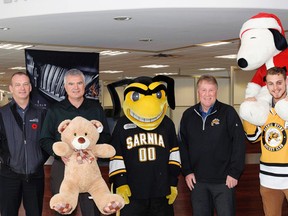 The Sarnia Sting are hosting their annual teddy bear toss game on Dec. 4 against the Niagara IceDogs. From left are Sting defencemen Jordan Ernst and Alex Black, Blackburn Radio's Ron Dann, Lambton Ford president Rob Ravensberg, Sting mascot Buzz, team president Bill Abercrombie, and Sting players Kevin Spinozzi and Jaden Lindo. (Handout)