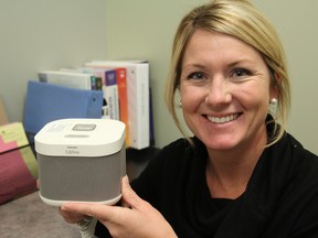 Michelle Shepherdson, the manager of the local Lifeline, which supplies medic alert systems, holds the new GoSafe medic alert system, which allows the user to remain connected to an emergency response centre anywhere in Canada. (Michael Lea/The Whig Standard)