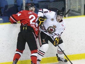 Sarnia Legionnaires forward Curtis Egert eyes the puck while Leamington Flyer Jaydon Fetter checks him during the Greater Ontario Junior Hockey League game at Sarnia Arena on Tuesday, Nov. 1, 2016 in Sarnia, Ont. Sarnia won 2-1 in double overtime. (Sarnia Observer file photo)