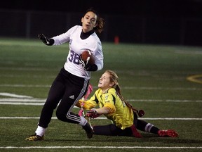 Marymount Regals running back Allison Byrnes is stopped by Confederation's Kayleigh Coufal during the high school Division A flag football championships at James Jerome Sports Complex on Tuesday night. Gino Donato/The Sudbury Star