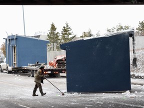 A truck carrying a shed hit an overpass at 66 Street and Fort Road in Edmonton Wednesday morning. (Shaughn Butts/Postmedia)