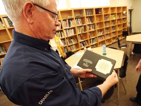 Charles Liddle from the Lions International shows some of the reading material they use to examine children’s vision in the Seaforth Public School’s library. (Shaun Gregory/Huron Expositor)