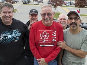 Jarmo Stromberg, centre, is surrounded by some of the hockey mates who saved his life last week, Chet Couture, left, Mike Forster, Tom Wells and John Mollica. Stromberg, 61, suffered sudden cardiac arrest while playing hockey, but was saved by fast-acting fellow players and a hockey rink defibrillator. (DEREK RUTTAN, The London Free Press)