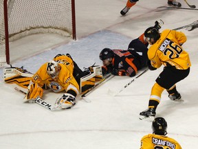 Kingston Frontenacs goalie Jeremy Helvig makes a diving save on a shot from Flint Firebirds’ Mathieu Henderson during the first period of Ontario Hockey League action at the Rogers K-Rock Centre on Oct, 28. (Julia McKay/The Whig-Standard)